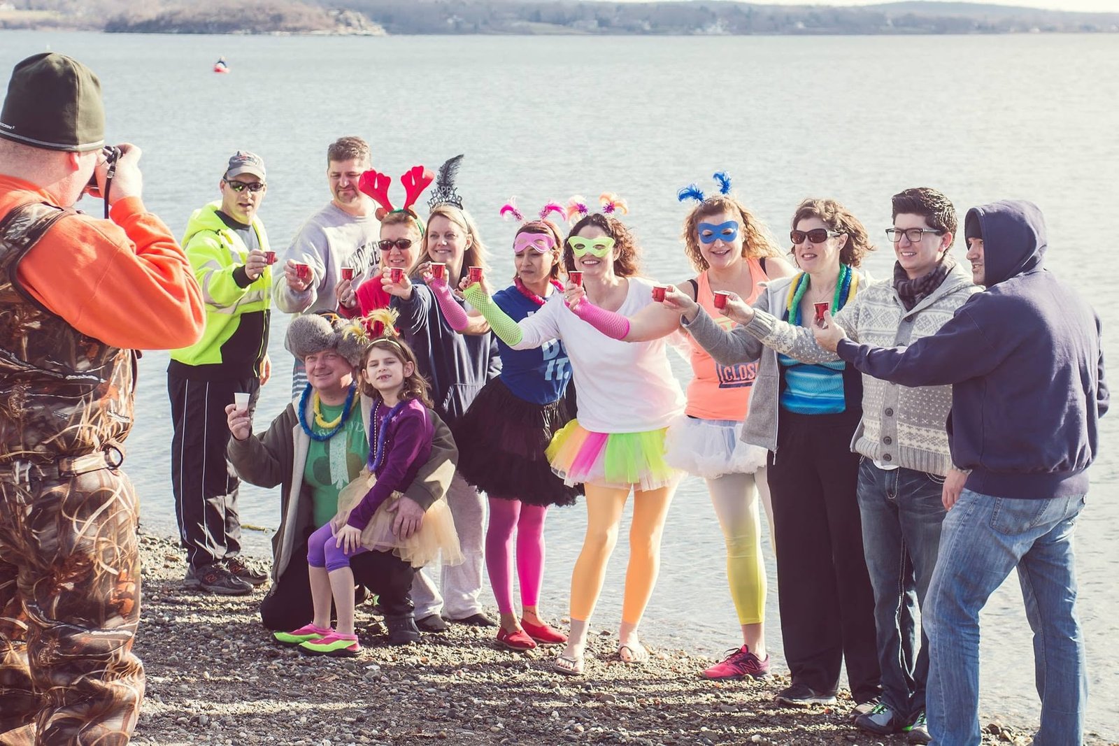 Costumed Polar Dive participants toasting on the beach